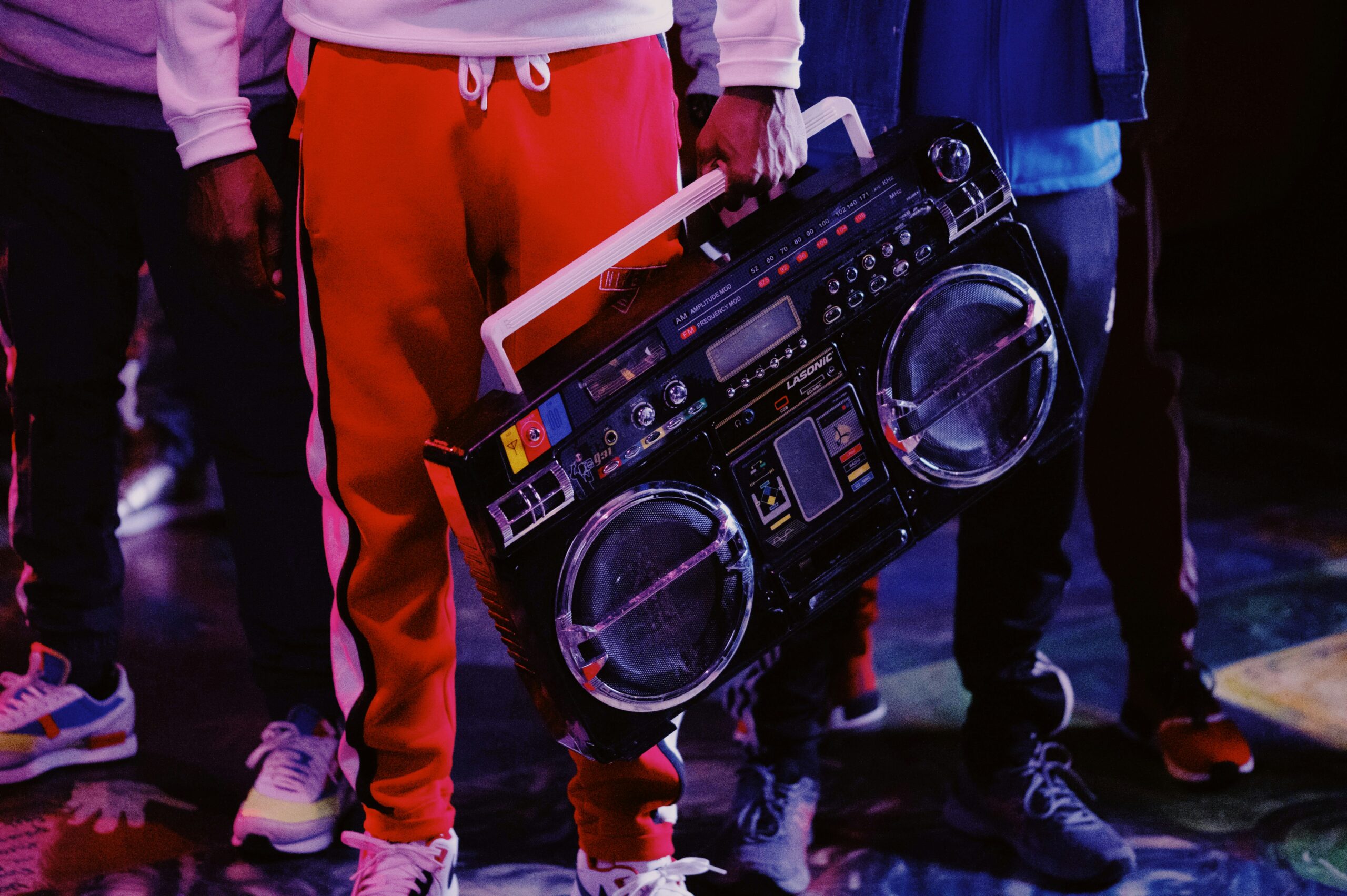 man in red jacket holding black dj controller